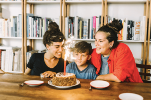 two moms celebrating their son's birthday all together after moms had parenting therapy in Simi Valley, ca